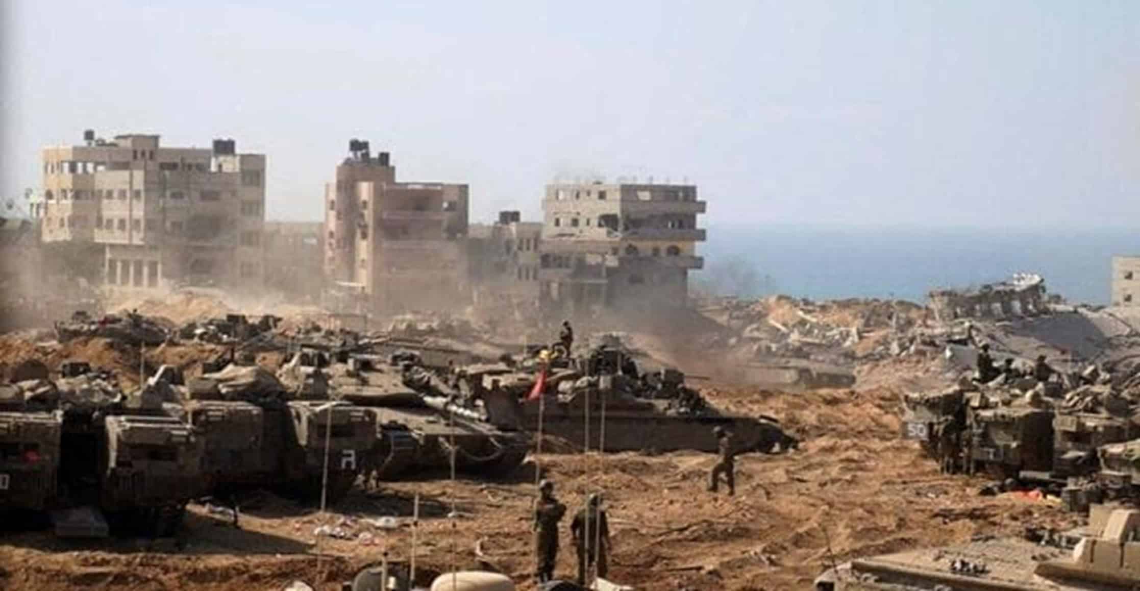 Israeli tanks and armored vehicles around the Gaza border in May. The steel and aluminum used to make weapons are very carbon-intensive to produce. Photo: Ariel Shalit/AP